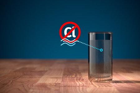 Uncontaminated drinking water by chlorine after filtration concept. Water in drinking glass and symbol of no Cl chemical in water.の写真素材