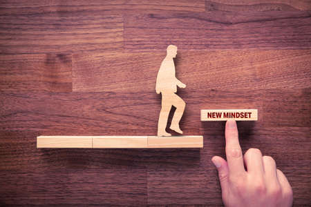 New mindset motivation concept with wooden blocks. Set new philosophy of life in new era after crisis to improve your life and start growth.の写真素材