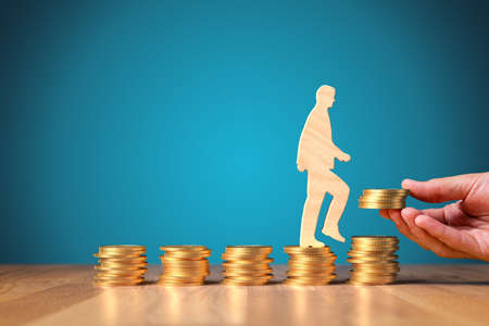 Change return on investment, growing savings or wage income concept. Wooden person is going from constant bucket of coins to growing coins. Successful investment concept.の写真素材