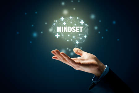 Positive mindset motivation concept with hand and graphics with symbols of brain, plus and text mindset. Be optimistic even in times of crisis motivation.の写真素材