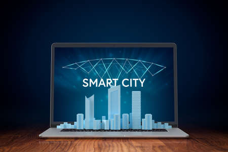 Smart city concept - communication technology (ICT) and Internet of things (IoT) technology integrated to manage city asset. Modern city model on notebook and smart city design.の写真素材