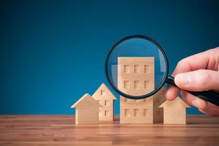 Focus on real estate and property insurance concept. Wooden models of different types of housesの写真素材