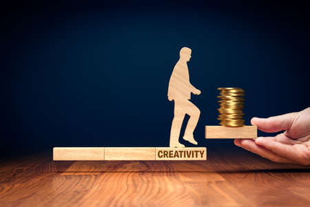 Monetize your creativity concept. Potential for financial growth based on your talent and creativity. Concept with wooden model of person, blocks and coins.の写真素材