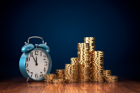 Time is money concept. It is five minutes to twelve for good investment concept. Alarm clock and coins.の写真素材