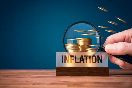 Focus on inflation concept. Columns of coins, part of coins fly away.の写真素材