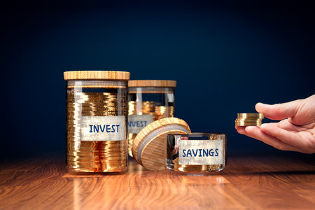 Money makes money investment versus savings concept. Big jars full of money with text invest. Small...