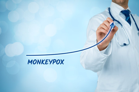Doctor practitioner and growing graph of monkeypox, blue background.の写真素材