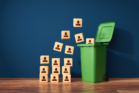 Visual metaphor of mass layoffs and redundancies, human resources concept. Dismissed from employment. Wooden cubes with employees represented by symbols and garbage cans.の写真素材