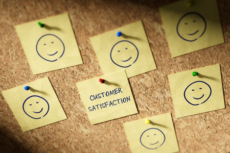 Customer satisfaction feedback concept. Customer care marketing concept. Notice board with yellow note cards and satisfied smileys on them.の写真素材