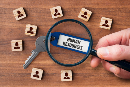 A well-functioning human resources are the key to the company's success. Human resources concept with key, key tag and wooden cubes with people symbol. Personnel is focused on successful human resources.の写真素材