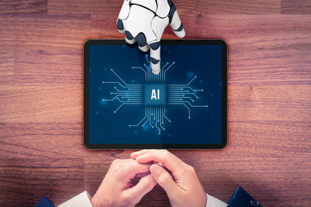 Artificial intelligence (AI) concept with robotic hand pointing at tablet and hands of business person, top view flatlay composition.の写真素材