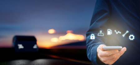 Intelligent car app on smart phone concept, intelligent vehicle and smart cars concept. Mobile phone user and family car in background, wide composition.の写真素材