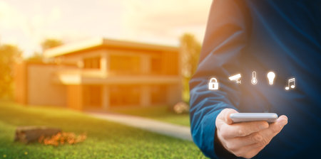 Smart home and intelligent house concept with modern villa house in sunset light in background.の写真素材