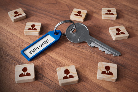 Employees are the key to the company's success. Human resources concept with key, key tag and wooden cubes with people symbol.の写真素材