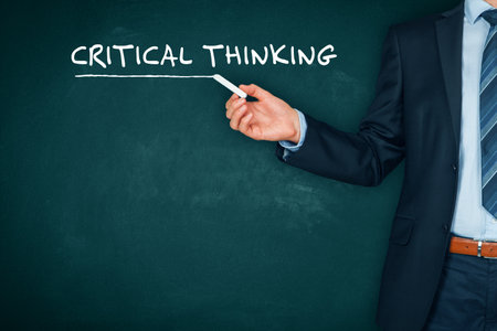 Critical thinking is the most important skill today. Educational concept with teacher in front of chalkboard with text critical thinking.の写真素材