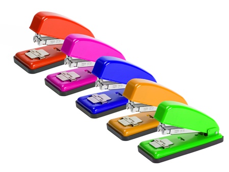 Row of multi colored staplers on white backgroundの写真素材