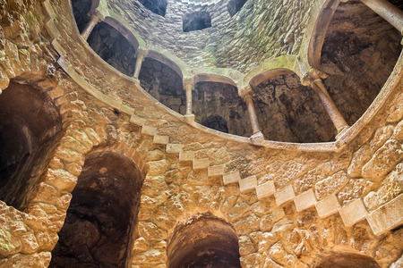 Sintra, Portugal - July 04, 2012: The Initiation well of Quinta da Regaleira in Sintra, Portugal. It's a 27 meter staircase that leads straight down underground and connects with other tunnels via underground walkways.のeditorial素材