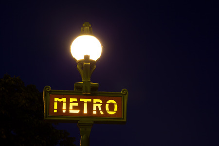 Paris Metro sign iluminated at nightのeditorial素材