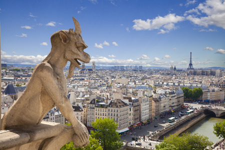 Notre Dame of Paris: Famous Chimera (demon) overlooking the Eiffel Tower at a summer dayの写真素材