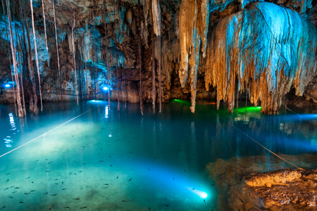 Cenote Dzitnup near Valladolid, Mexico. lovely cenote with transparent turquoise waters and large stalactitesの写真素材