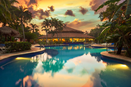Luxury swiming pool in a tropical resort at sunsetのeditorial素材