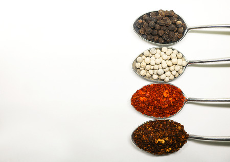 Spicy seasoning. Thai spices on spoon. Pepper and caryenne pepper.の写真素材