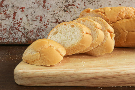 fresh bread slide on wooden cutting board