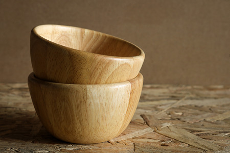 Pile empty wood bowl on rustic wooden background.の写真素材