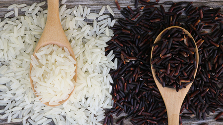 Riceberry in wooden spoon on rustic wood background. Jasmine rice and Riceberry rice it's variety rice that originates from Thailand. Jasmine rice and Riceberry have delicious, nutty taste and characteristic flowery aroma and rich in many antioxidant and many health benefitsの写真素材