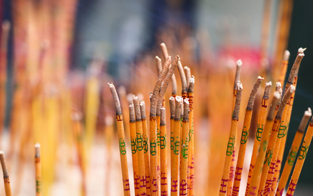 Incense sticks burning embossed in Chinese temple. Oriental buddhist style worship of god in temple or shrine.の写真素材