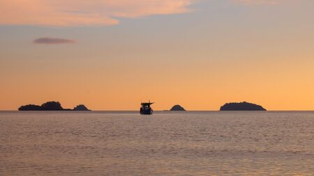 Fishing boat on the sea at summer sunset time. Seascape of sunset at Koh Chang island, Trat Thailand.の写真素材