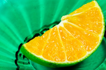 orange slice on green plateの写真素材