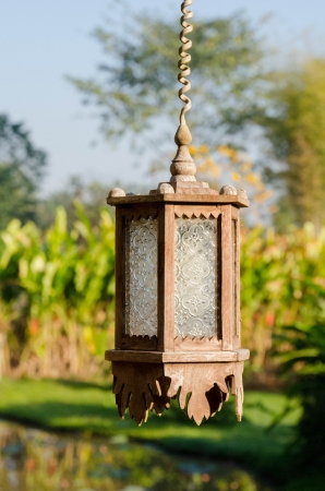 wooden hanging lamp with background of garden の写真素材