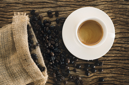 Cup Of Coffee On Wood Table With Coffee Beans. Color Tonedの写真素材