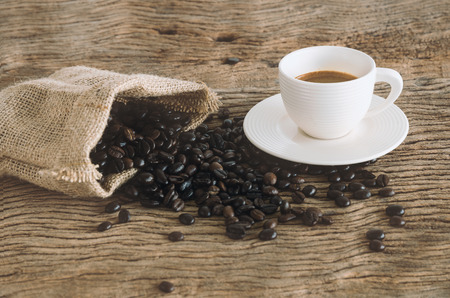 Cup Of Coffee On Wood Table With Coffee Beans. Color Tonedの写真素材