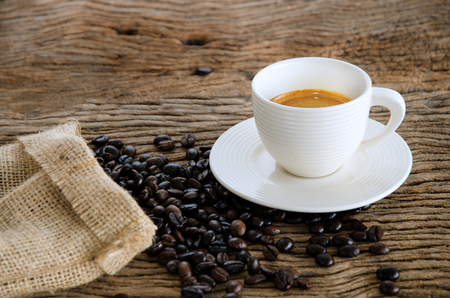 Cup Of Coffee On Wood Table With Coffee Beans.の写真素材