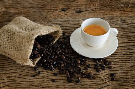 Cup Of Coffee On Wood Table With Coffee Beans.の写真素材