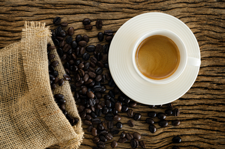 Cup Of Coffee On Wood Table With Coffee Beans.の写真素材