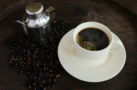 Cup Of Coffee On Wood Table With Coffee Beans.の写真素材