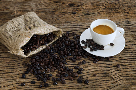 Cup Of Coffee On Wood Table With Coffee Beans.の写真素材