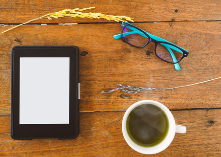E-Book, E-reader With Glasses And Hot Green Tea On Wood Table. Top Views.の写真素材