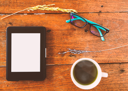 E-Book, E-reader With Glasses And Hot Green Tea On Wood Table. Top Views.の写真素材