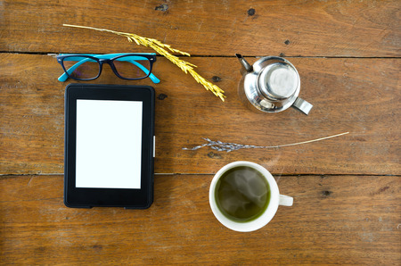 E-Book, E-reader With Glasses And Hot Green Tea On Wood Table. Top Views.の写真素材
