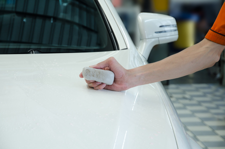 Hand Polishing By Clay Bar And Clay Lubricant For Remove Dirt On Car Surface And Show Dirty On Clay Barの写真素材