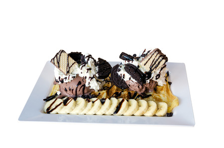 Waffle And Chocolate Ice Cream With Banana and Wafers Whipped Cream On Top Isolated On White Background.の写真素材