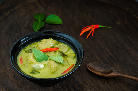 "Kang Keaw Wan Fish Ball"  Traditional Thai  food. Green Coconut Milk Curry Thai  Herb And Spices With Fish Balls On Wood Tableの写真素材