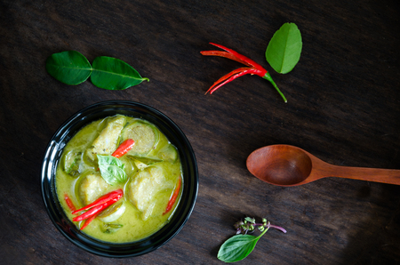 "Kang Keaw Wan Fish Ball"  Traditional Thai  food. Green Coconut Milk Curry Thai  Herb And Spices With Fish Balls On Wood Tableの写真素材
