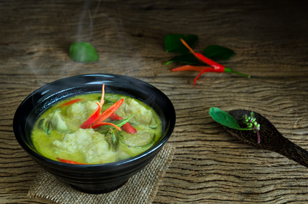 "Kang Keaw Wan Fish Ball"  Traditional Thai  food. Green Coconut Milk Curry Thai  Herb And Spices With Fish Balls On Wood Tableの写真素材