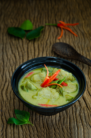 "Kang Keaw Wan Fish Ball"  Traditional Thai  food. Green Coconut Milk Curry Thai  Herb And Spices With Fish Balls On Wood Tableの写真素材