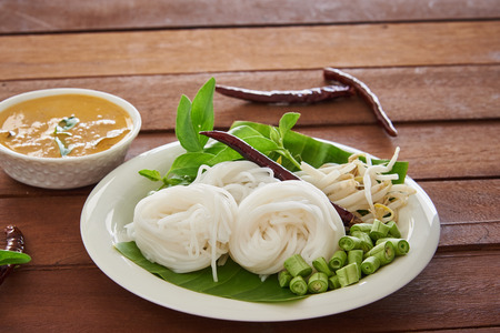 Kanom Jeen Nam Ya Pla, Rice Noodles With Coconut And Fish Red Curry With Fresh Vegetables On Wooden...